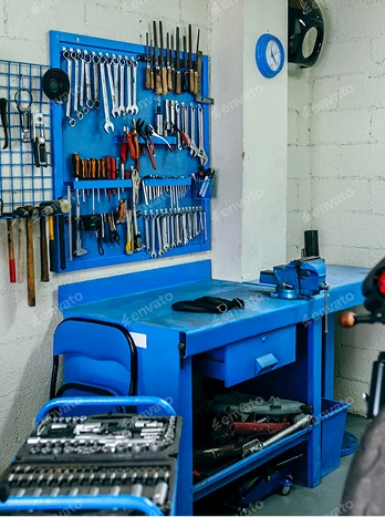 Blue pegboard tool organizer with workbench, rolling storage cart, and organized hand tools in garage workshop - Cleaning in the DC Metro area.