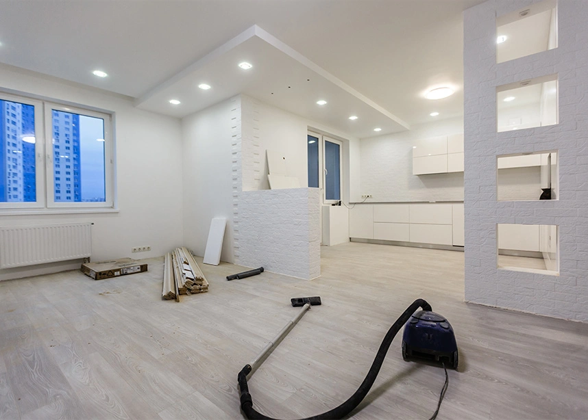 Modern white minimalist room under renovation with exposed flooring and construction materials