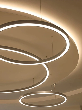 Modern circular LED pendant lights with warm glow illuminating ceiling in contemporary interior design - Eletrical work in the DC Metro area.